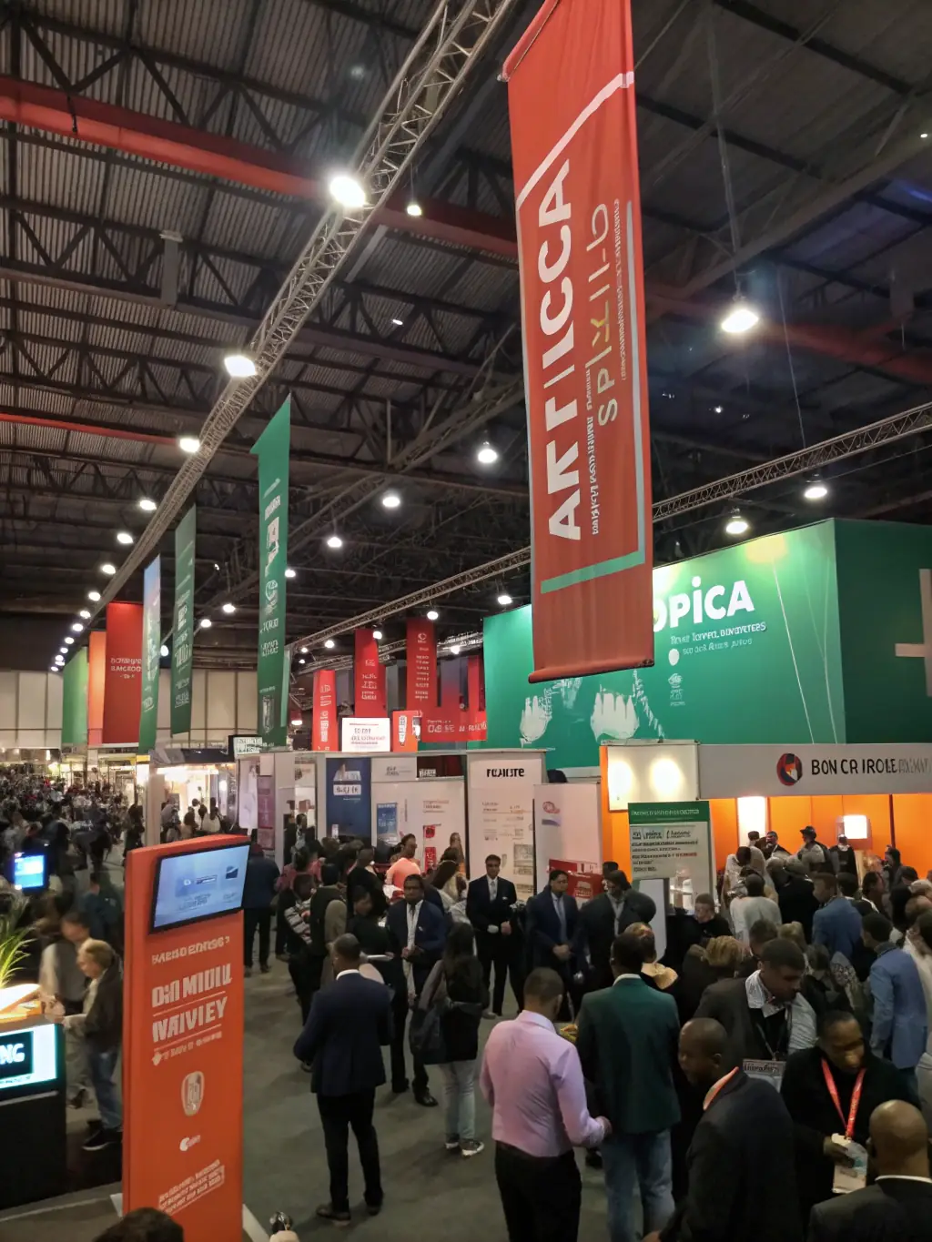 A vibrant image of the Johannesburg Expo Centre during the Africa Tech Week conference, showcasing a diverse crowd of attendees and exhibitors.